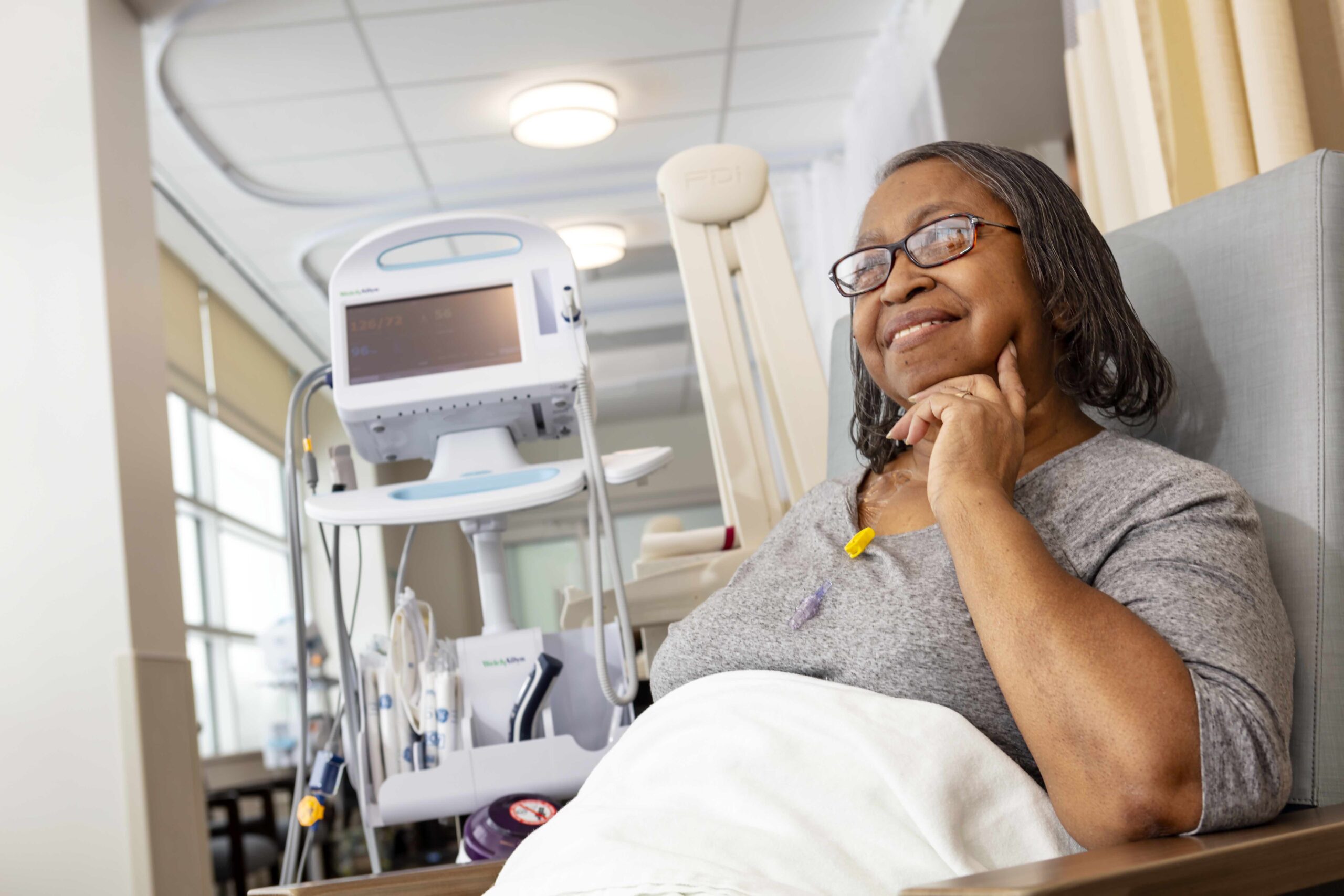 Madison Health cancer care patient sitting and smiling.