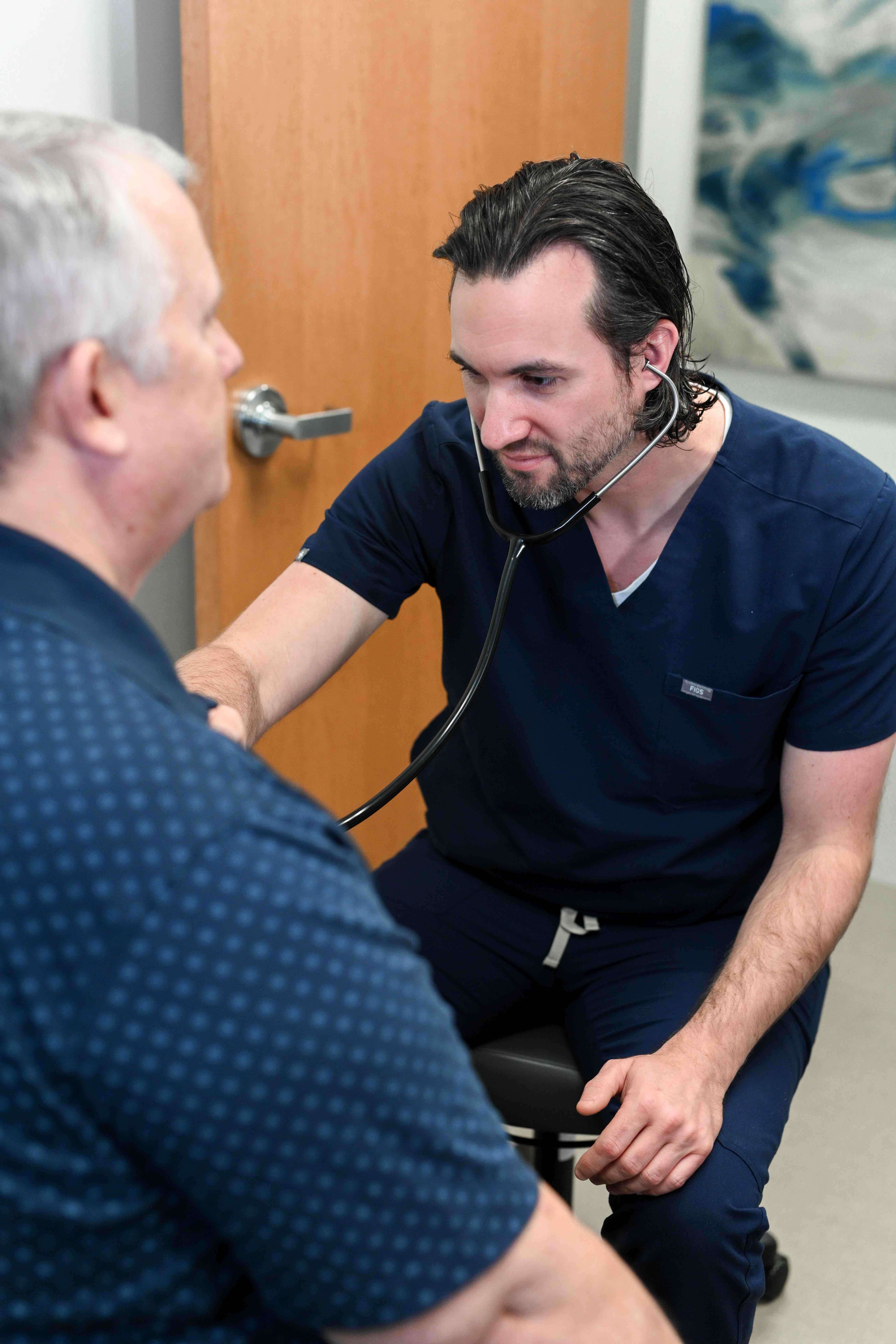 Madison Health Doctor listening with stethoscope to patient's chest