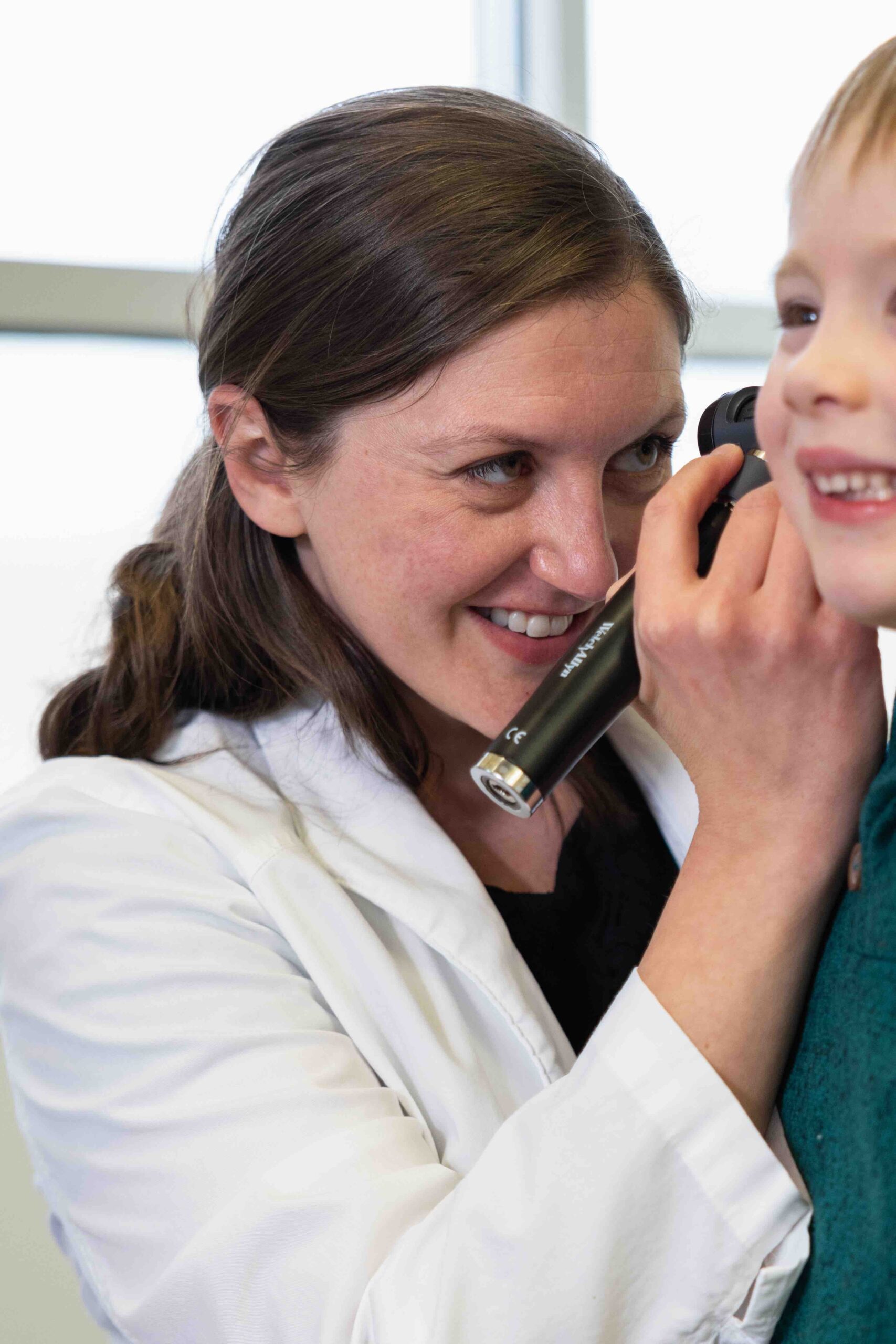 Madison Health Pediatrics doctor looking at child's ear
