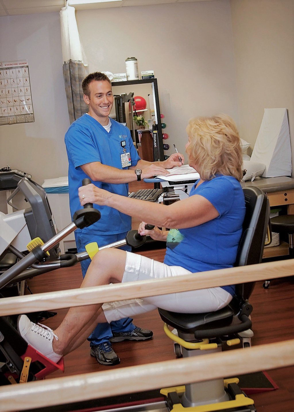 Doctor and patient in physical therapy working out arms and legs