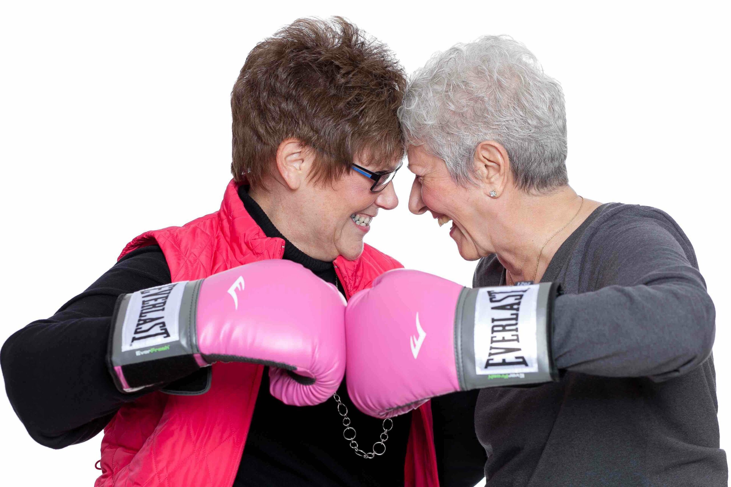 Breast Cancer Endowment, women punching fist with boxing gloves on.